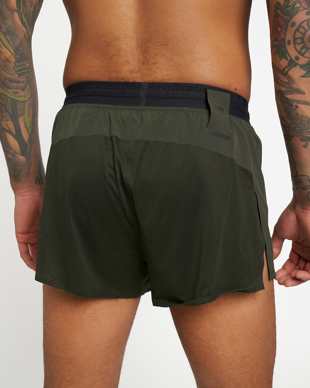 Elite Crag shorts in green with reflective, wicking fabric; features integrated waistband and inner fuel pockets for running.