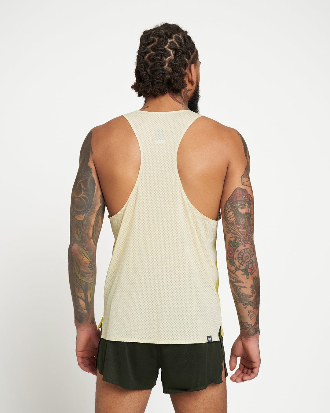 Back view of man wearing lightweight, reflective RDSinglet - Elite - Sogl with welded seams and moisture-wicking fabric.