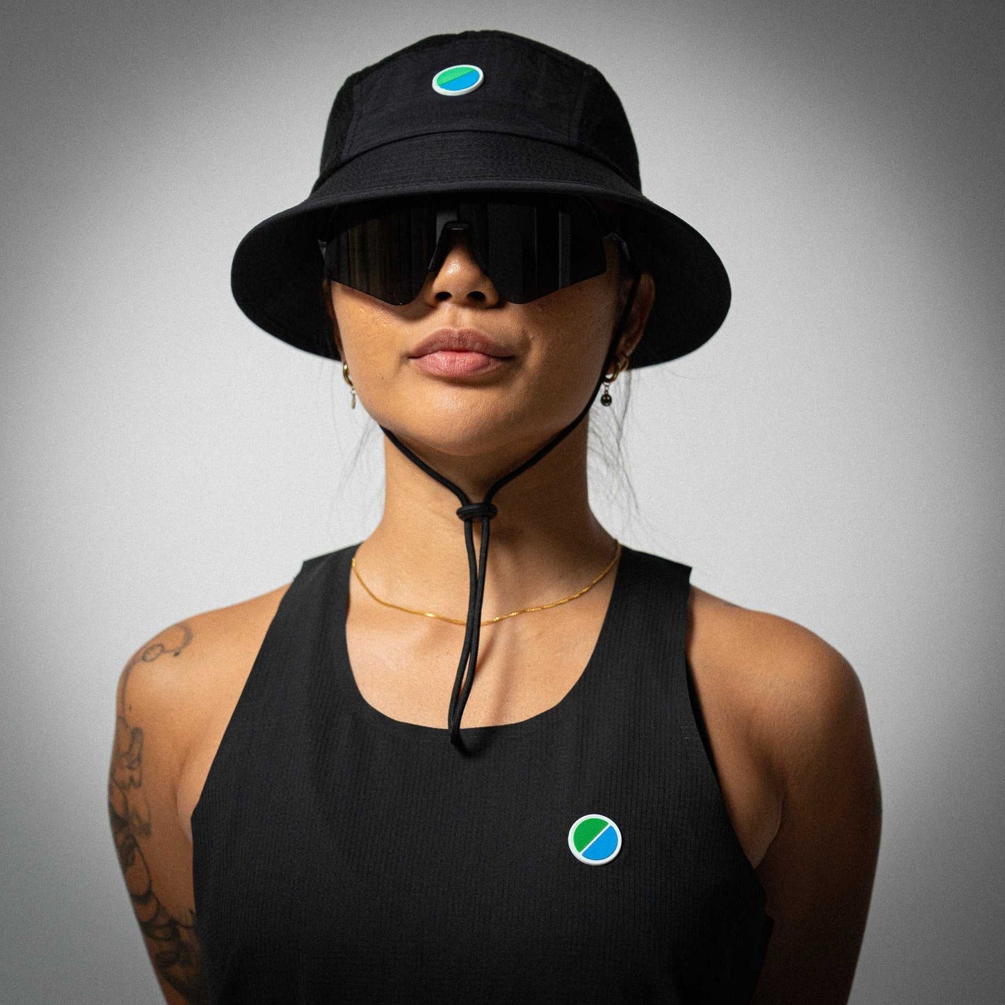 Black Aeria Fortis WMNS Race Tank, lightweight and breathable running top, with silicone chest patch and sustainable recycled materials.