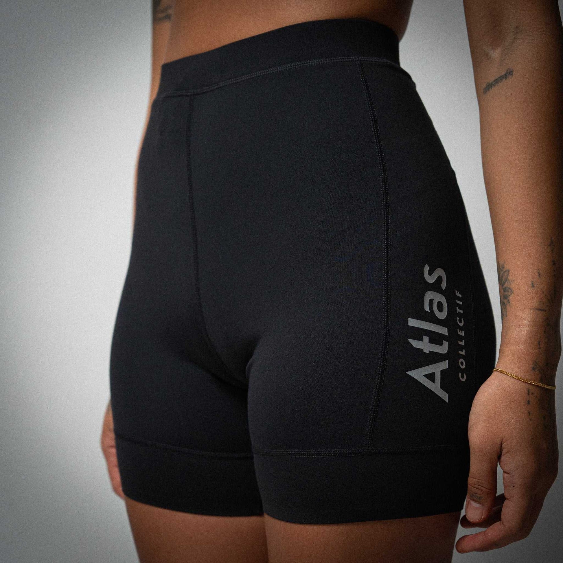 Illumi Trax WMNS Running Half Tights in black with reflective detailing and storage pockets.