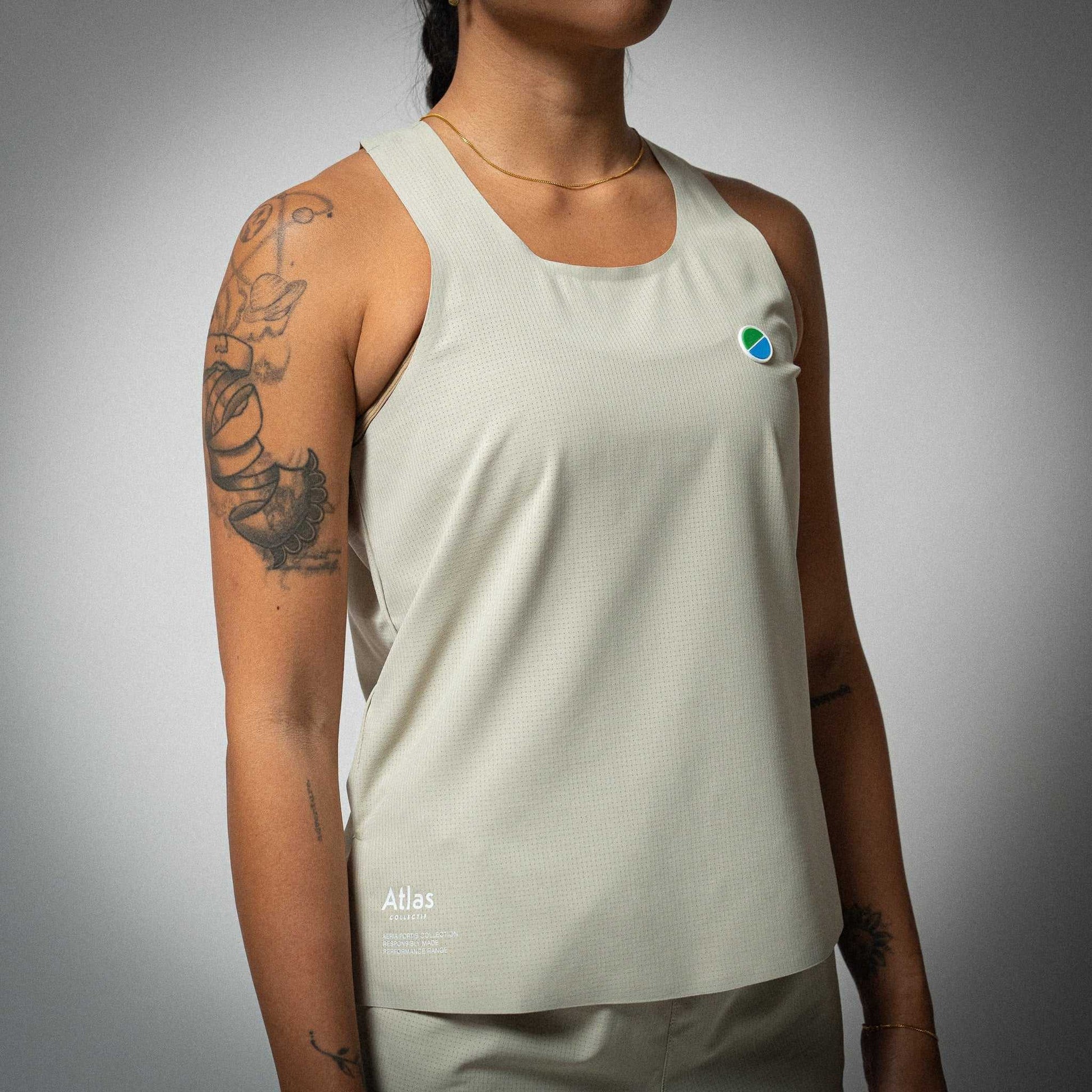 Aeria Fortis WMNS Race Tank Beige in recycled ripstop fabric with silicone branding patch.