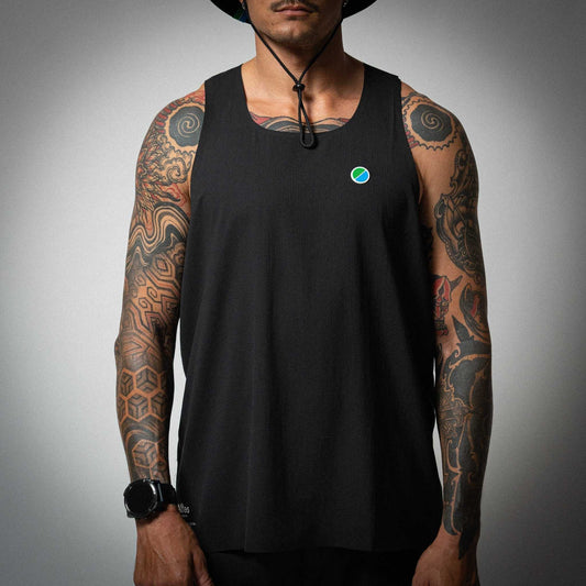 Aeria Fortis Race Tank in black worn by a model, showcasing breathable recycled ripstop fabric with silicone chest patch for runners.