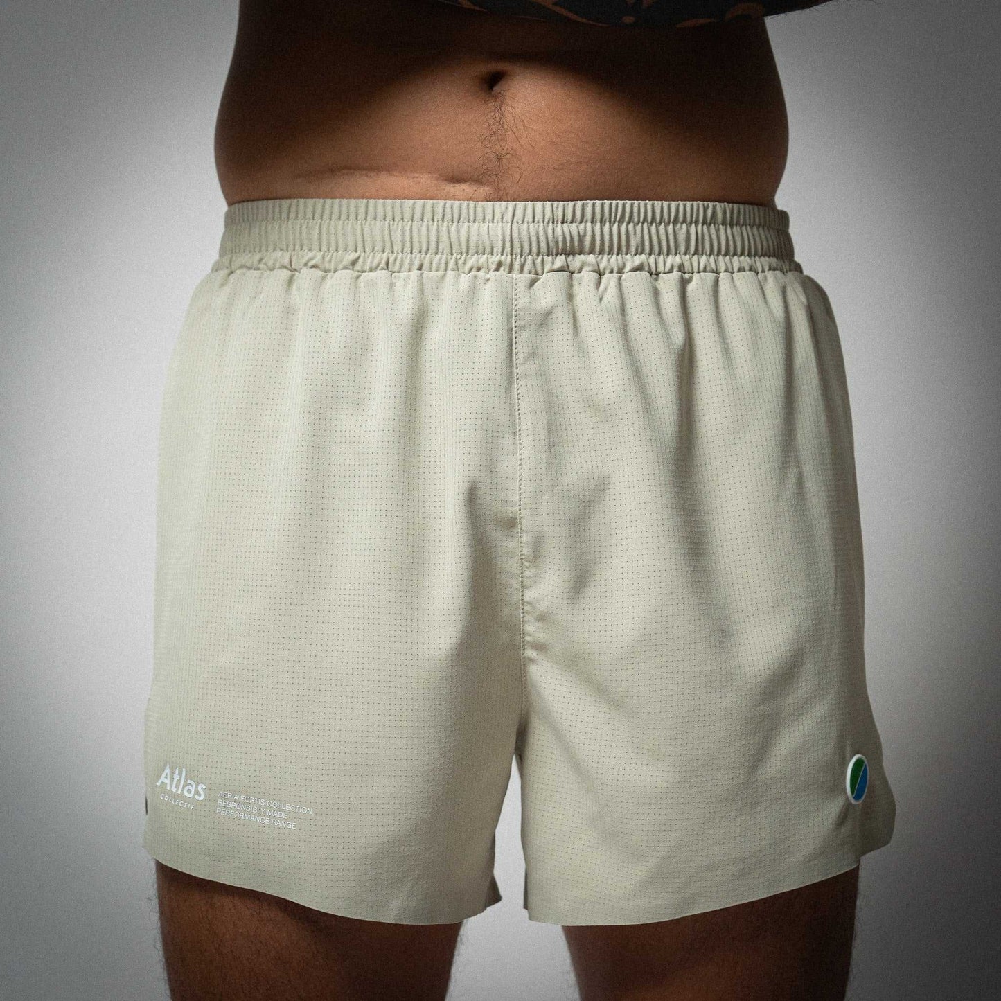 Aeria Fortis 4" Race Shorts in beige featuring seamless construction and lightweight design for performance running.