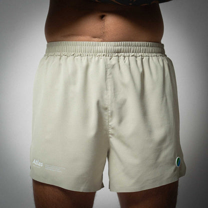 Aeria Fortis 4" Race Shorts in beige featuring seamless construction and lightweight design for performance running.