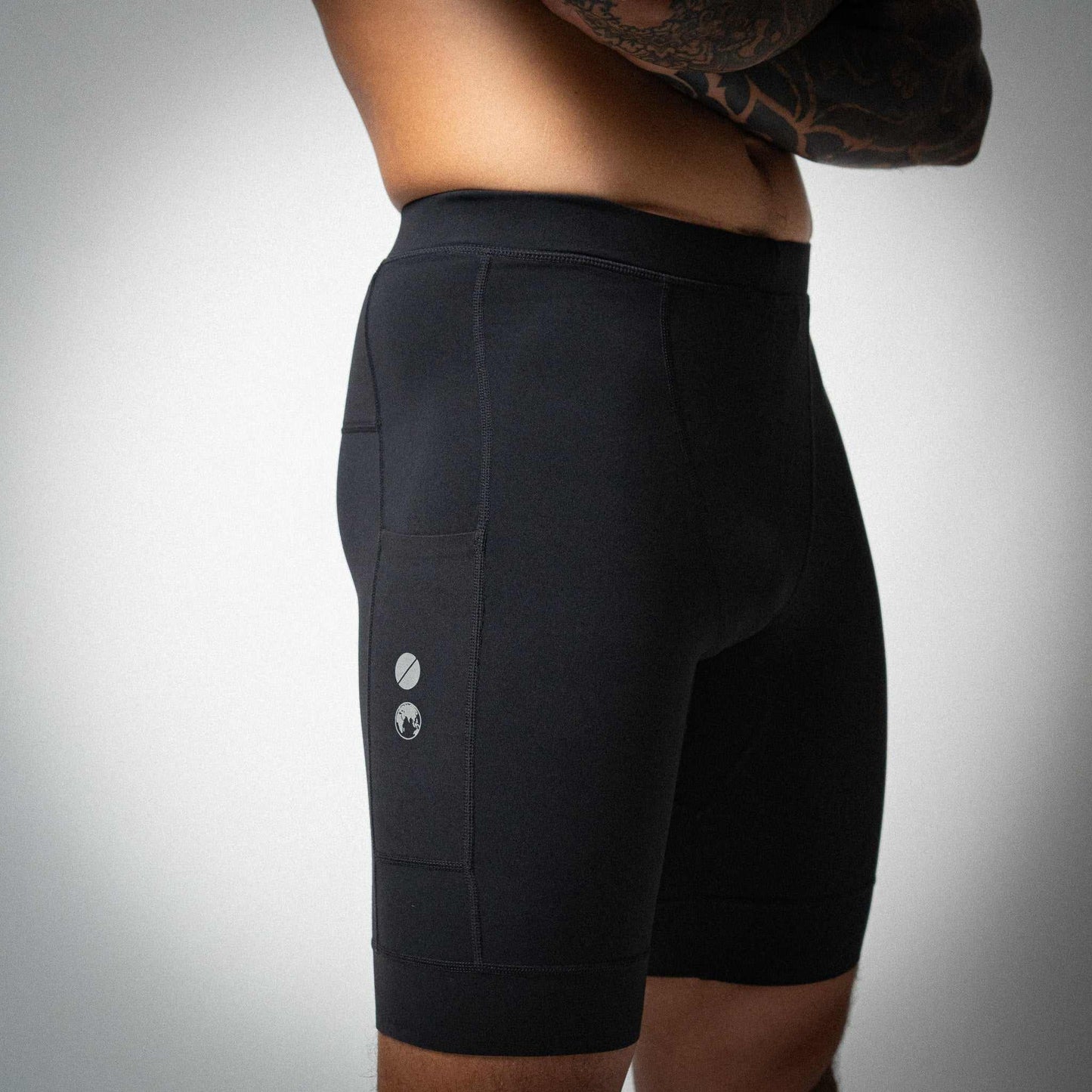 Illumi Trax Half Running Tights in black showing side pocket and supportive fit.