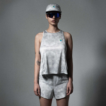 V3 Core WMNS Race Tank in grey tie-dye with eco-friendly polyester, reflective details, and side slits for running.