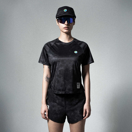 Eco-friendly V3 Core WMNS T-Shirt in black tie-dye with raglan sleeves, modeled by a person.